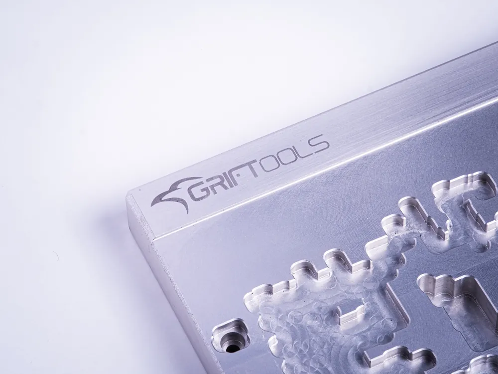 Edge of a machined aluminium print support with the Griftools mark
