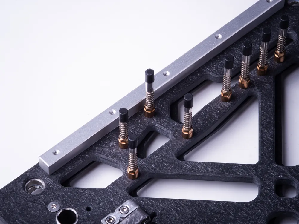 Machined corner of a wave solder carrier with aluminium rail and locating pin