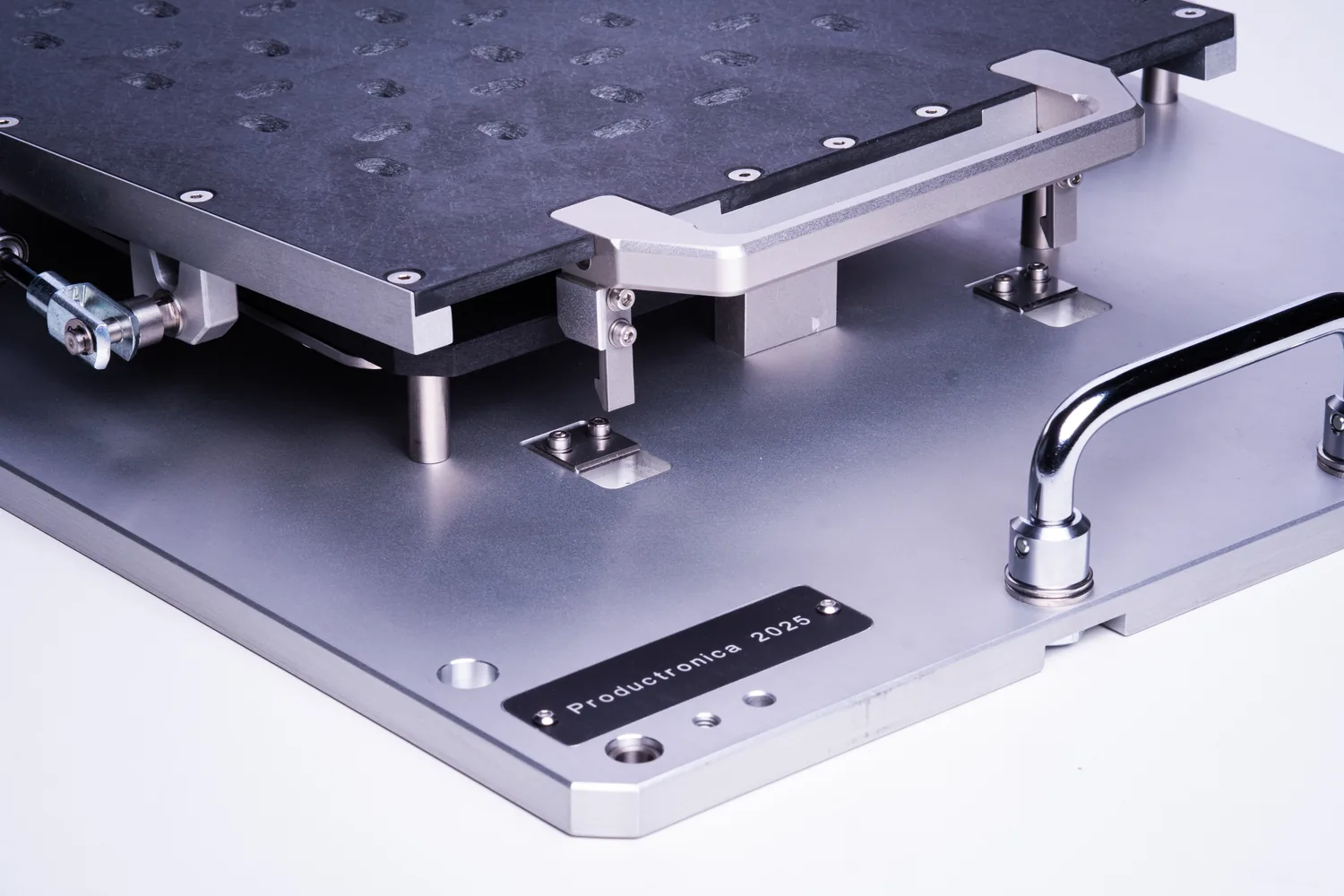 PCB depaneling fixture with a hinged pin bed, holding a routed panel