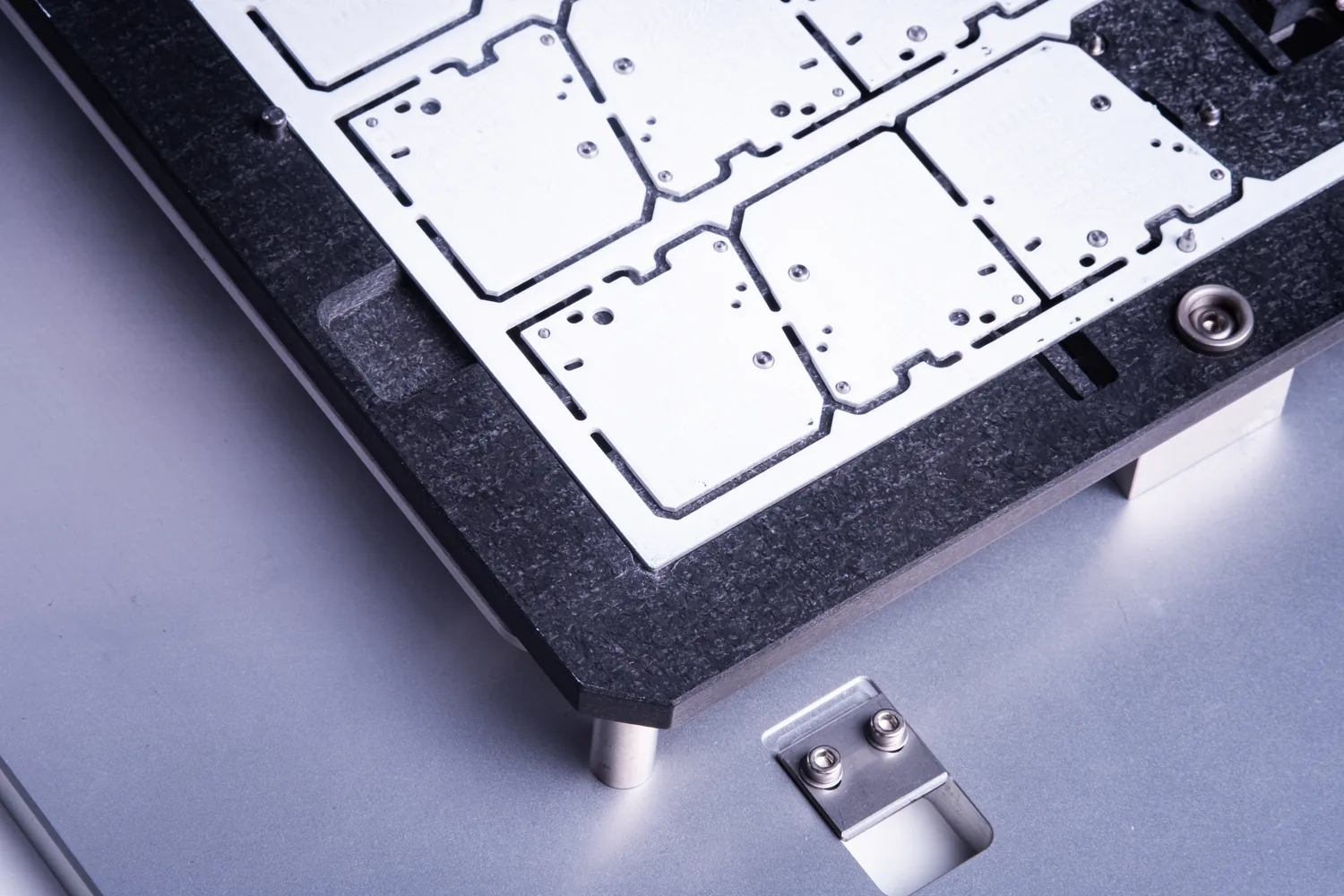 Routed PCB panel held in a depaneling fixture